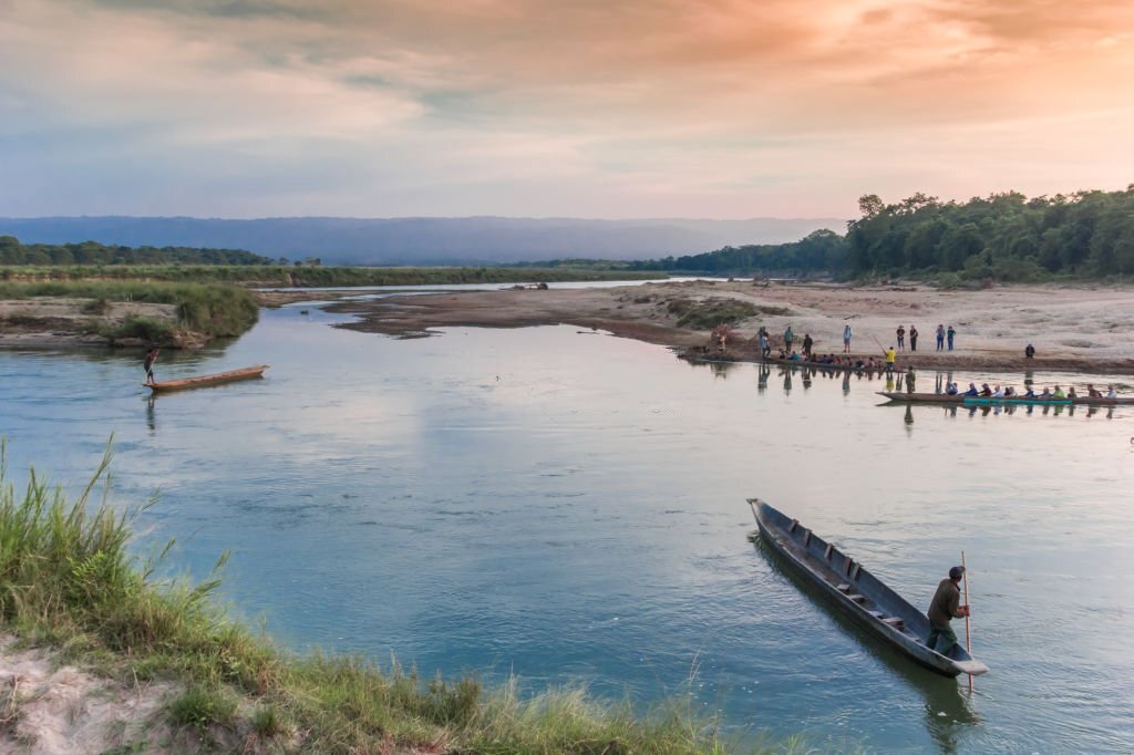 Wooden canoes crossing the river in Chitwan National Park, Nepal